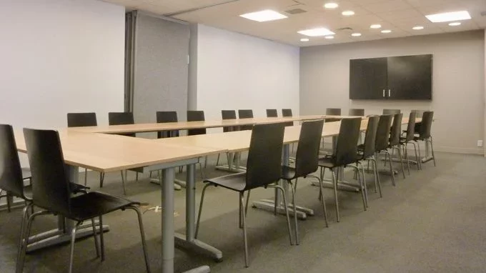 Conference room with white walls and long rectangular table